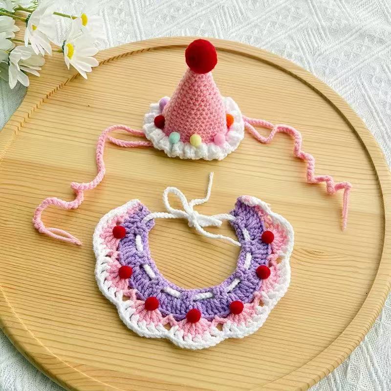 Pink and purple handmade crochet pet hat and collar set with colorful pom-poms, adjustable ties 