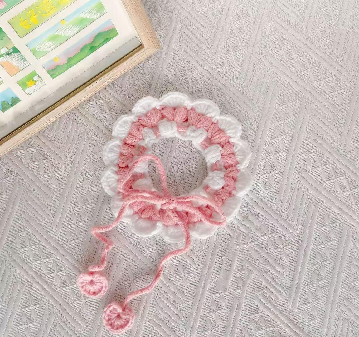 Close-up of handmade crochet pet collar in pink and white